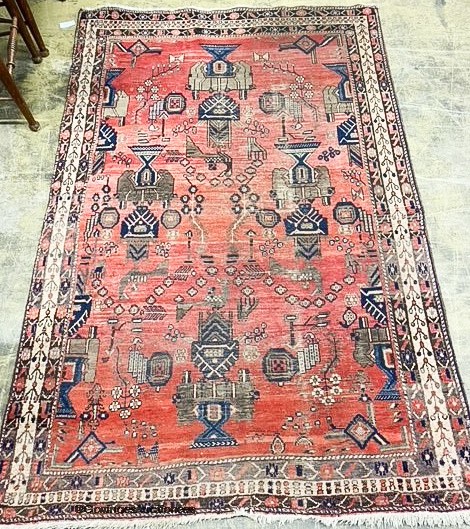 A Caucasian design red ground rug. 224x144cm.
